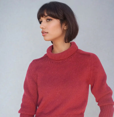 Audrey Horne Costume Model showcasing a cropped burgundy mock neck sweater, inspired by Audrey Horne from Twin Peaks.