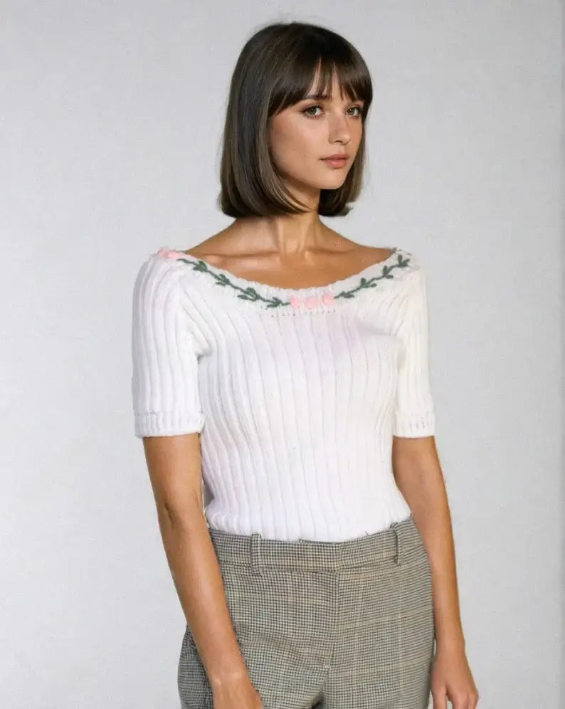 Marilyn Monroe off-shoulder knit top in white with floral embroidery, vintage-inspired design and short sleeves.