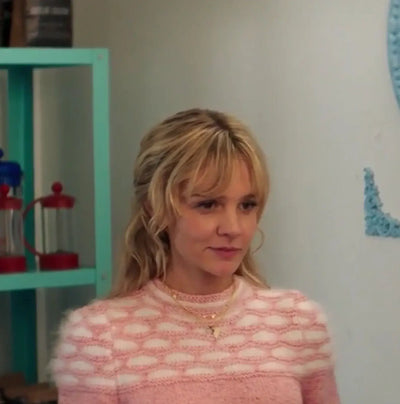 Carey Mulligan wearing a Honeycomb pink sweater from Promising Young Woman, showcasing her iconic style.