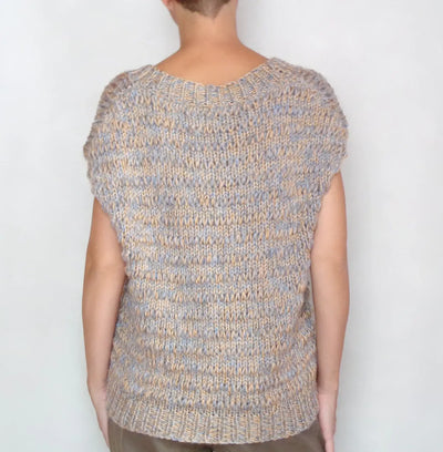 Back view of a loose, sleeveless V neck sweater vest, knitted from soft alpaca yarn in a multicolor pattern.