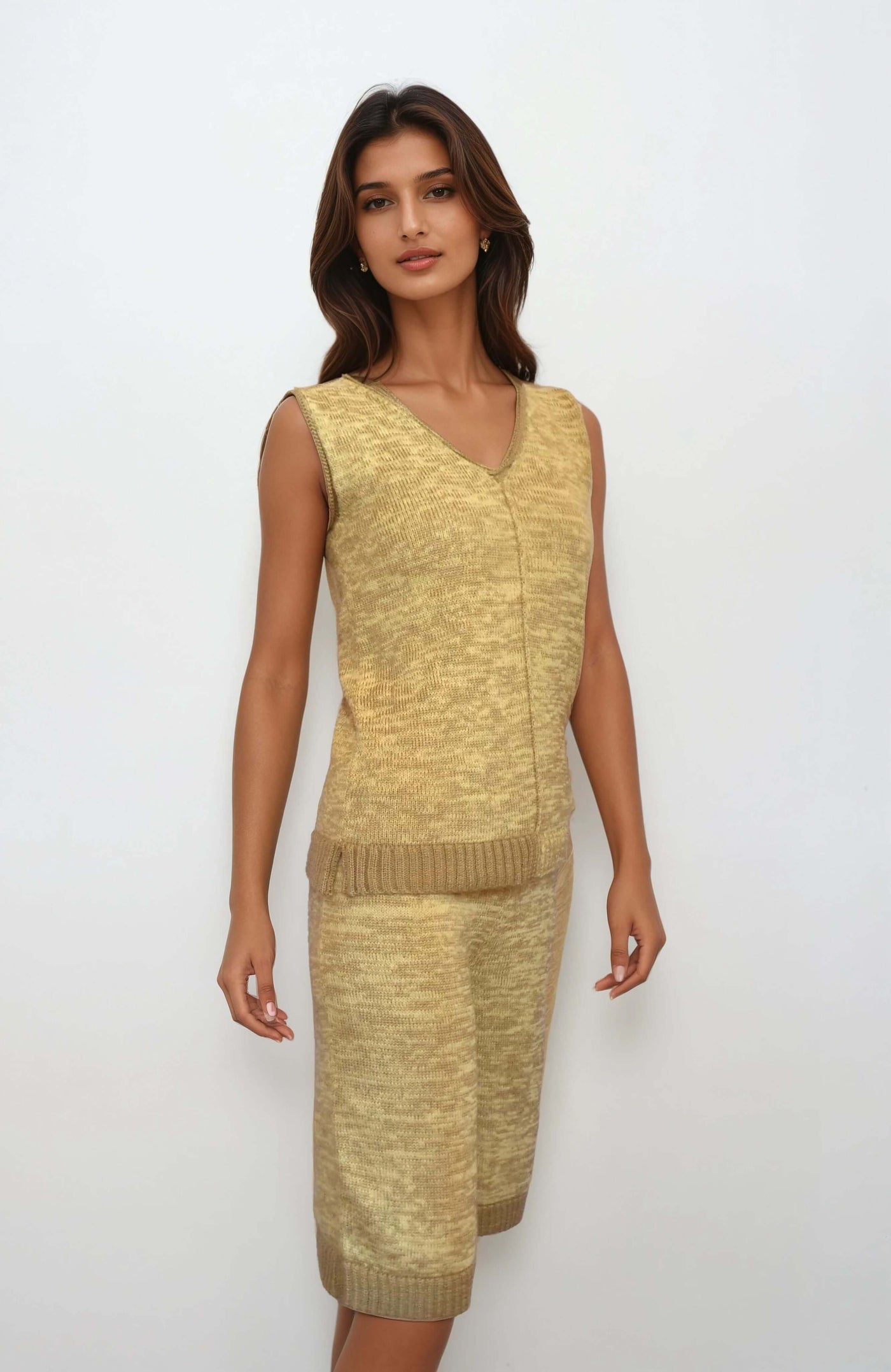 Model wearing a handmade knit set co-ord featuring a v-neck top and matching shorts in a gradient beige shade.