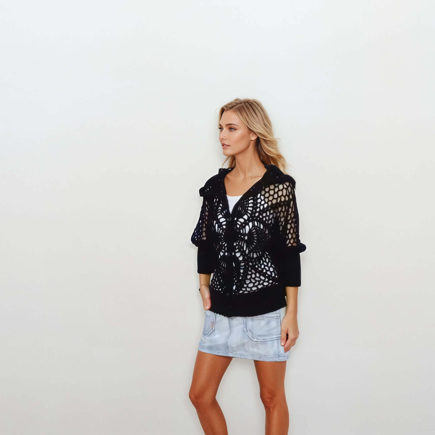 Black lace hooded crochet bomber jacket worn with denim skirt, perfect for summer style.