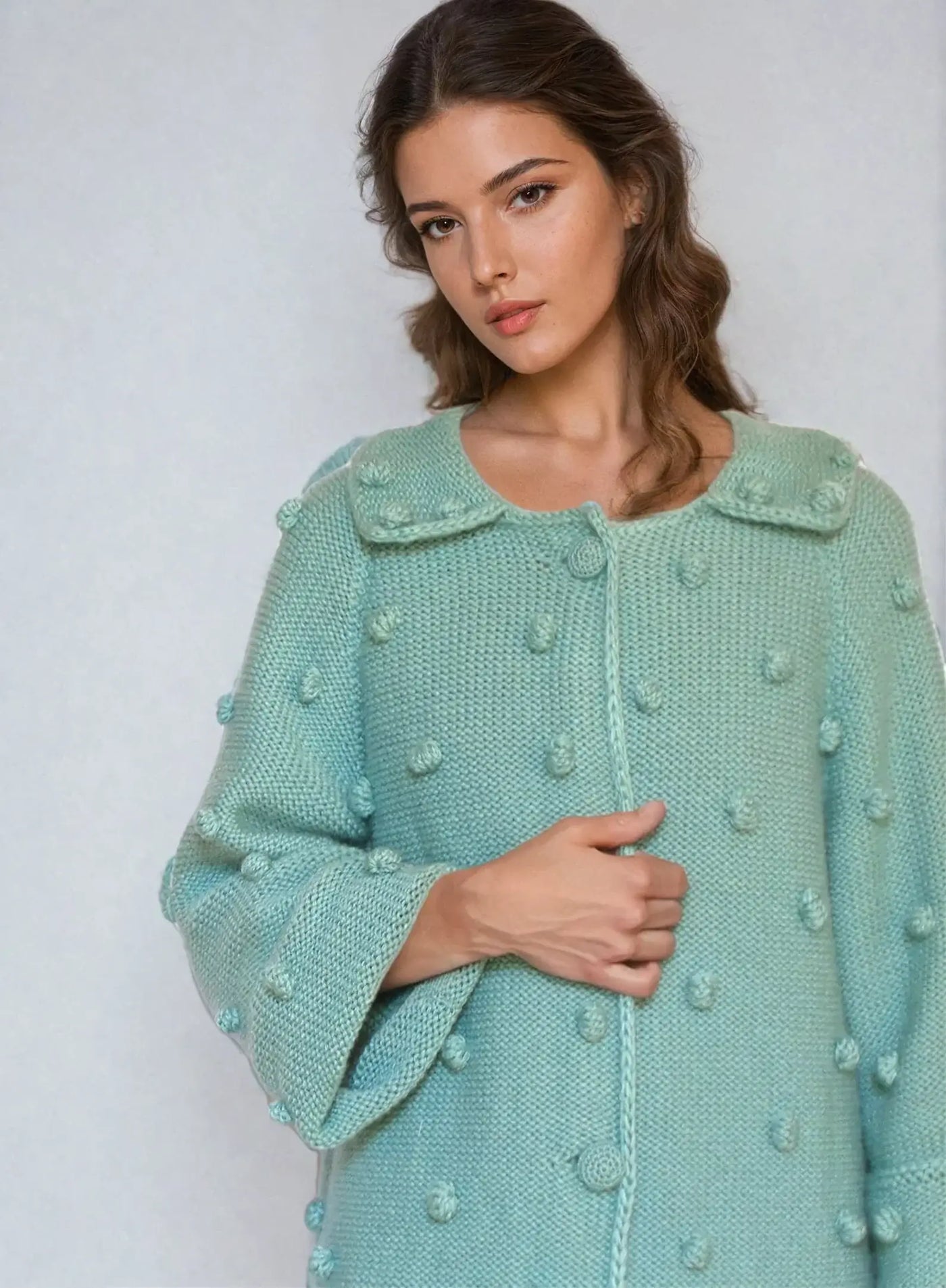 Turquoise knitted cardigan with bubble texture, showcasing a woman wearing a lightweight mohair cardigan.