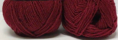 Two skeins of deep red yarn, perfect for knitting creative projects and handmade items.