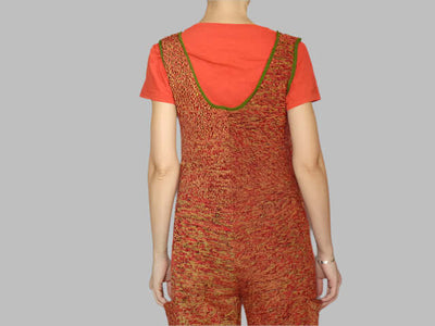 Back view of a short knitted jumpsuit for women in vibrant color gradient with pockets and V-neck design.