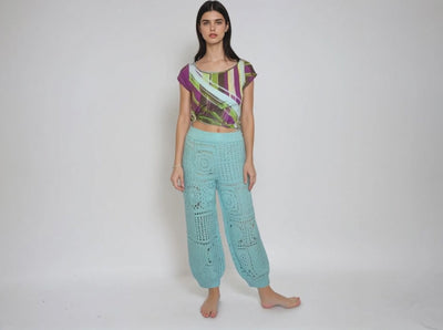 Turquoise high waisted harem pants with crochet granny square pattern, styled in a boho look.