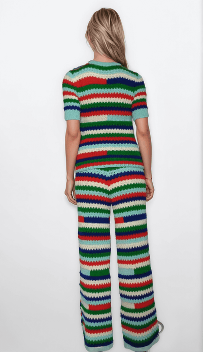 Back view of a multicolor striped two-piece pants set for women, featuring a hand-knit crochet design.