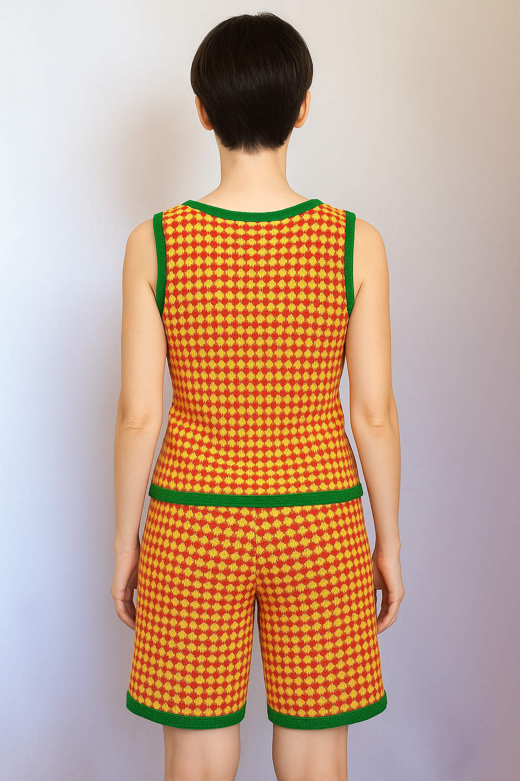 Women's summer look: knitted tank top and shorts with a geometric pattern in warm tones